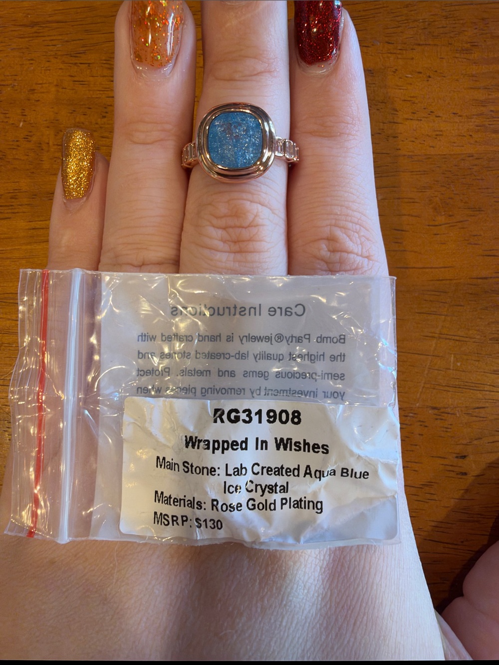 Wrapped In Wishes Rose Gold Ring with Aqua Blue Crystal Center